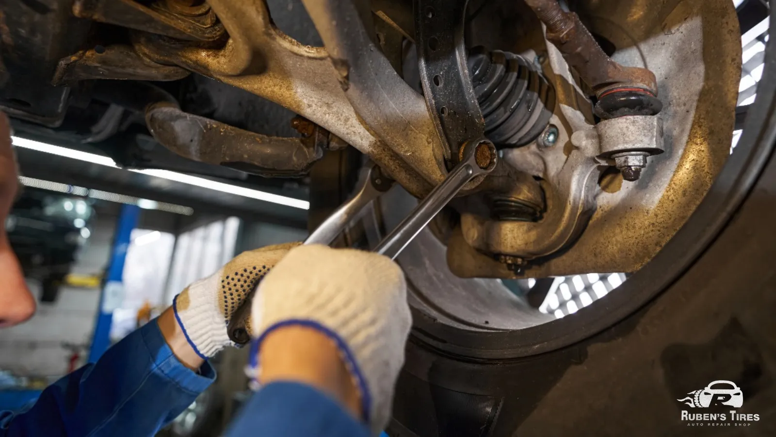 Technician repairing a suspension joint at Ruben's Tires in North Semoran.