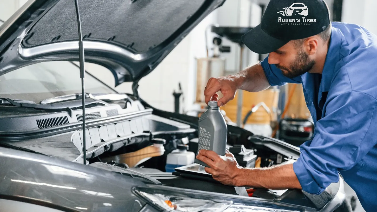 Mechanic performing an oil change service at Ruben's Tires in North Semoran.