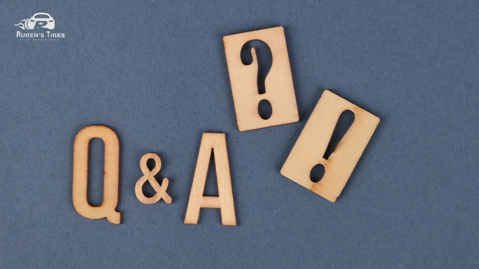 Wooden Q&A letters representing customer inquiries about body shop services at Ruben's Tires in North Semoran.