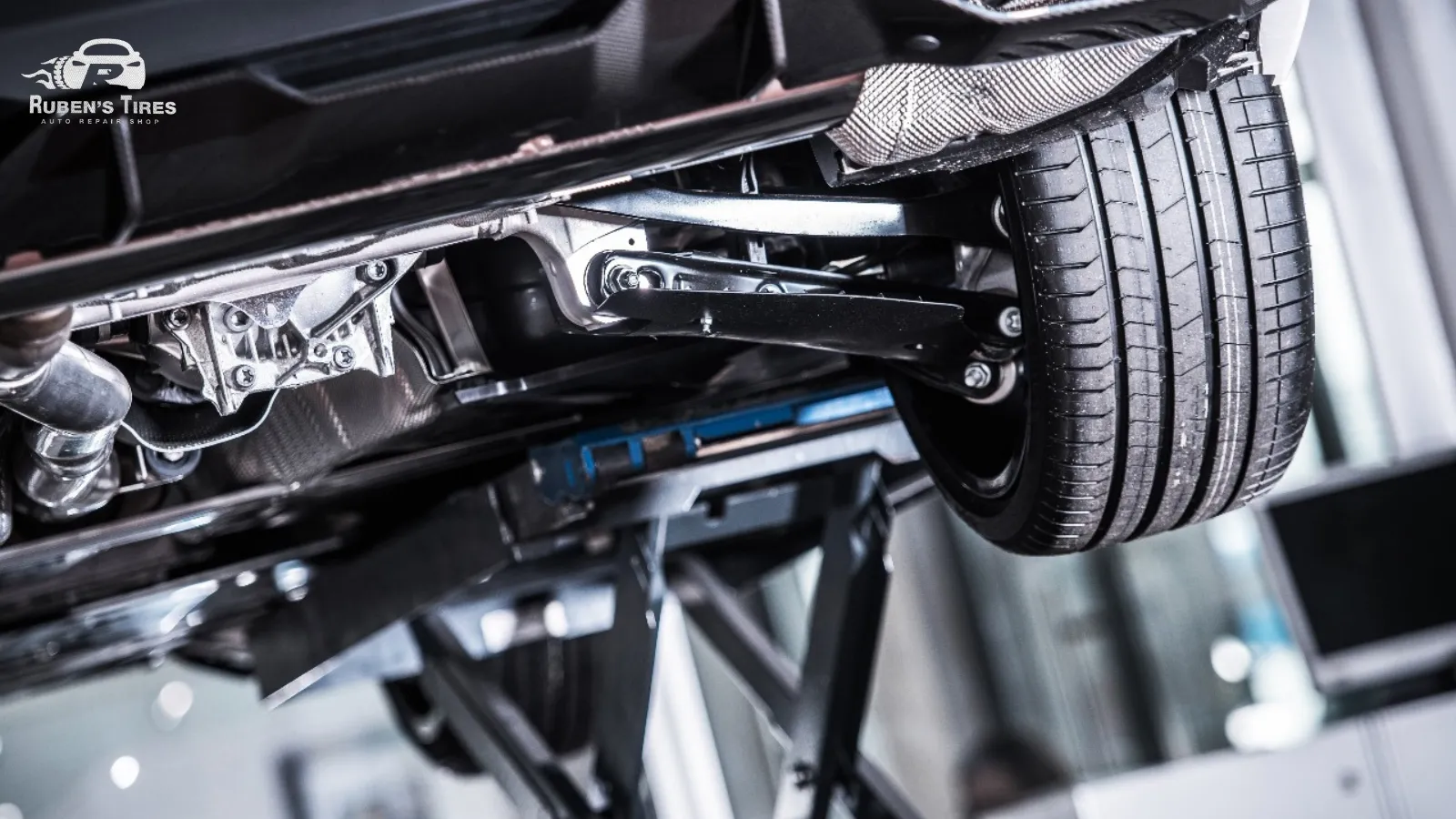 Close-up of a vehicle's undercarriage and suspension at Ruben's Tires, North Semoran.