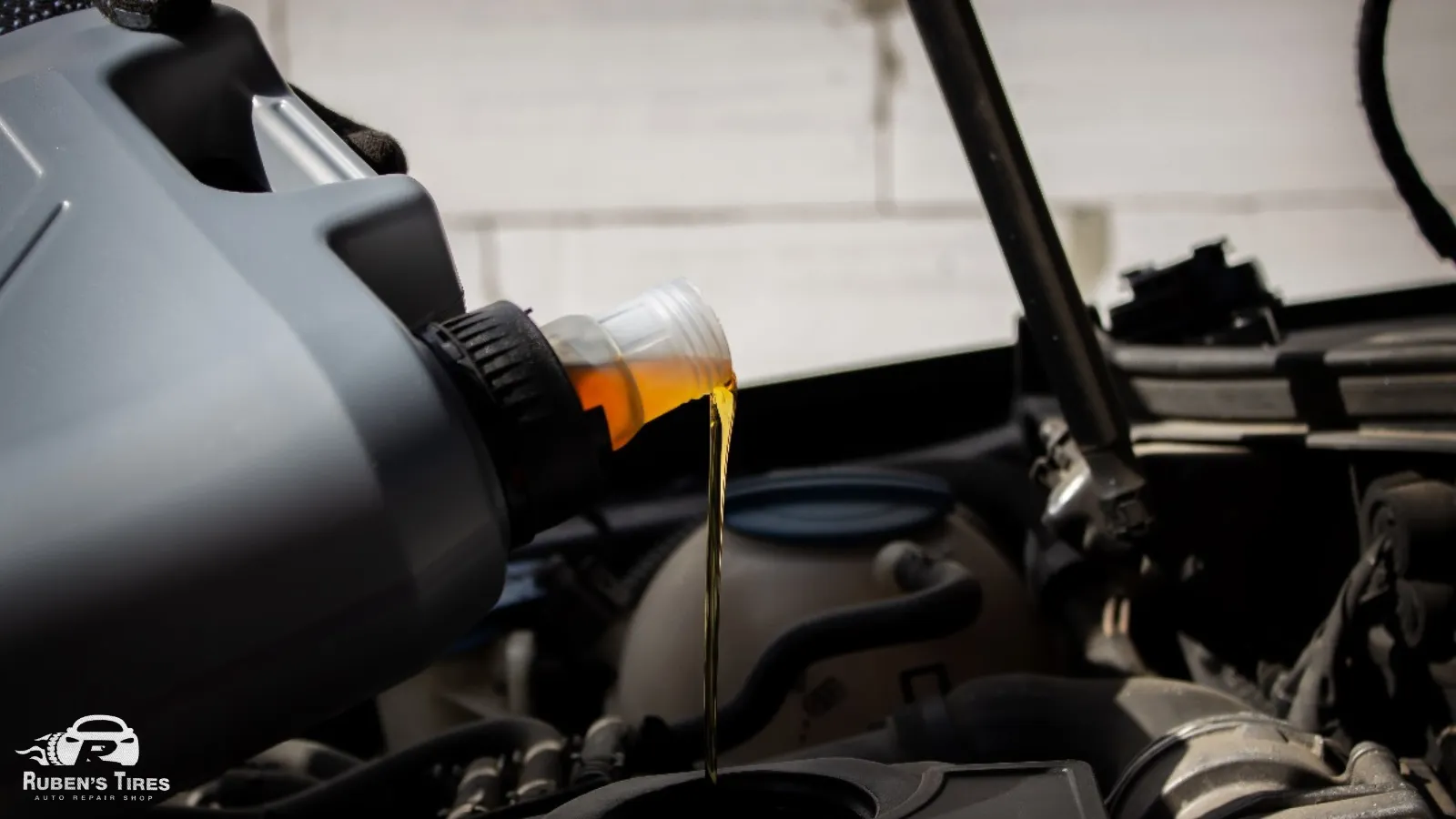 Fresh motor oil being poured into a car engine during an oil change in North Semoran.